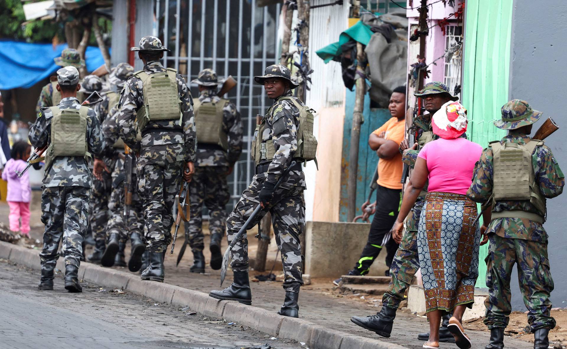 FILE PHOTO: A member of the Mozambique military, looks on as they patrol the streets of the capital a day after a "national shutdown" against the election outcome, in Maputo