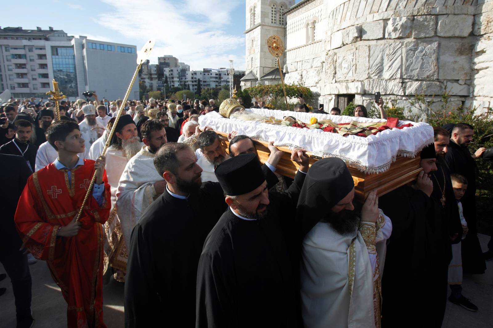 Priests carry the coffin of Metropolitan Amfilohije Radovic in Podgorica