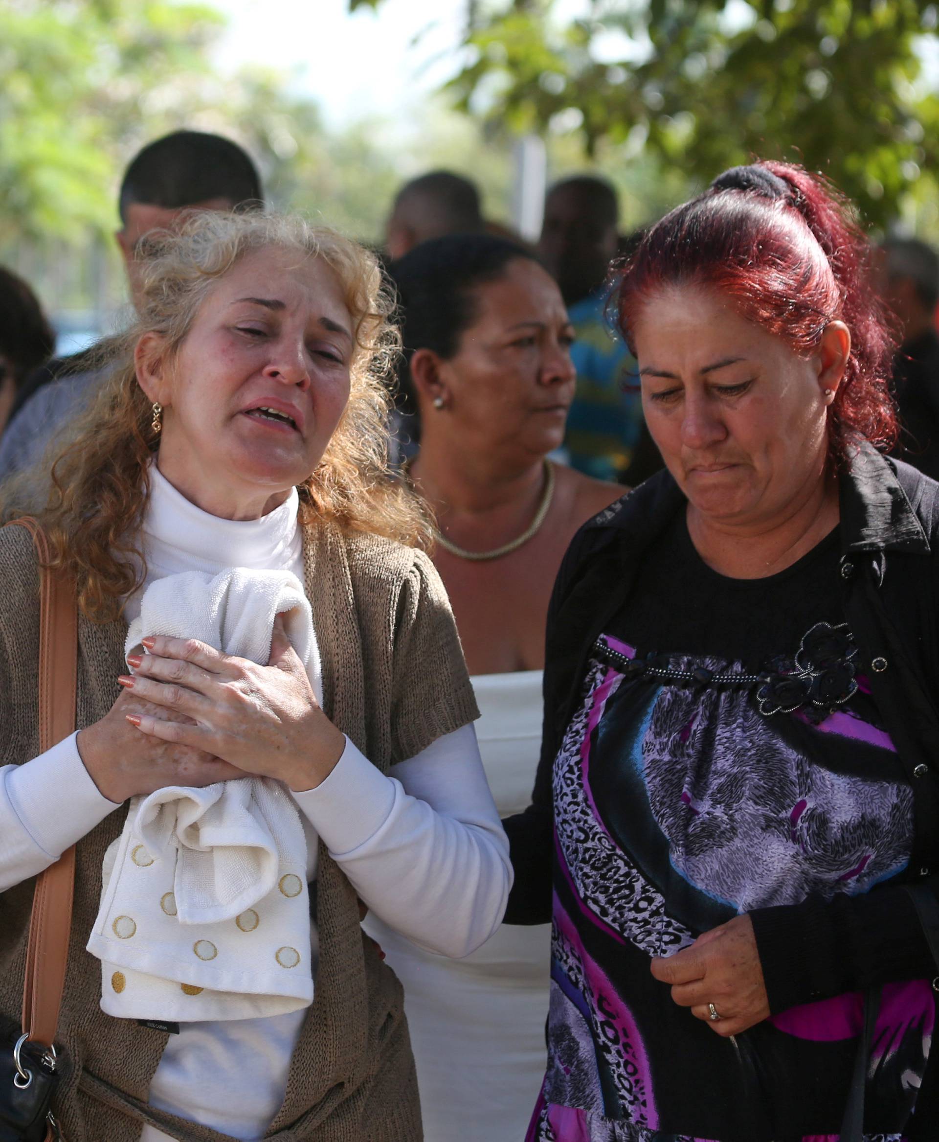Relatives of victims of the Boeing 737 plane that crashed after taking off from Havana's main airport yesterday, react as they leave the Legal Medical Institute in Havana