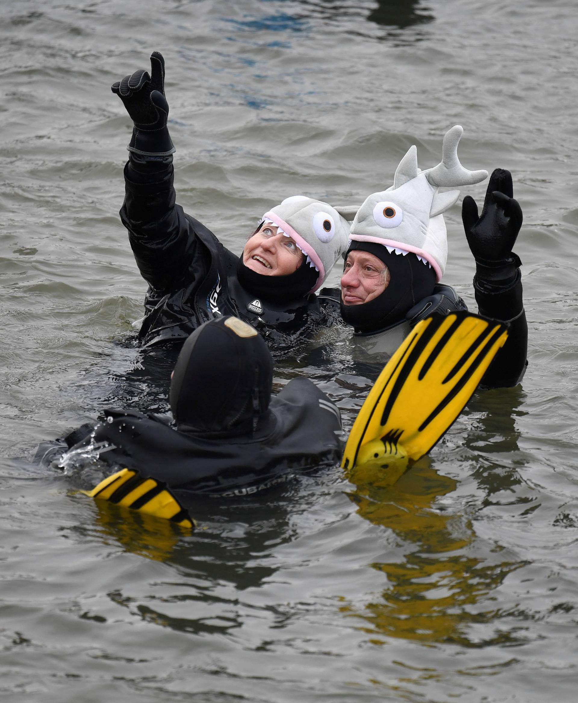 Swimmers wearing costumes bathe in the 3 degrees Celsius water of the river Danube in Neuburg an der Donau