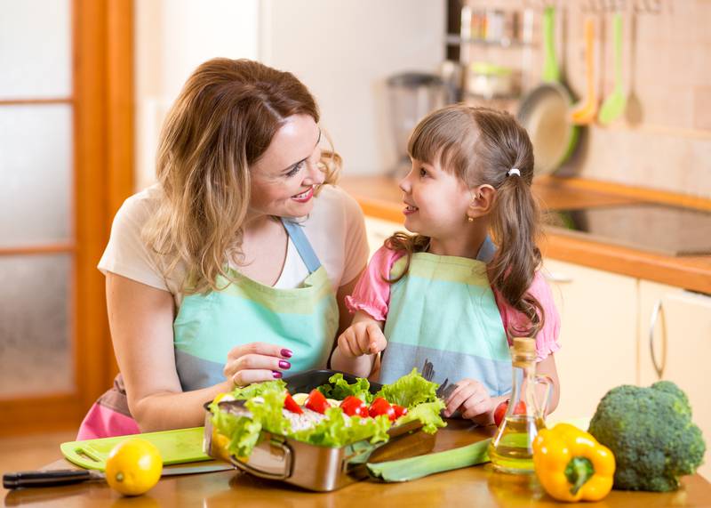 mother and kid cooking and having fun in kitchen