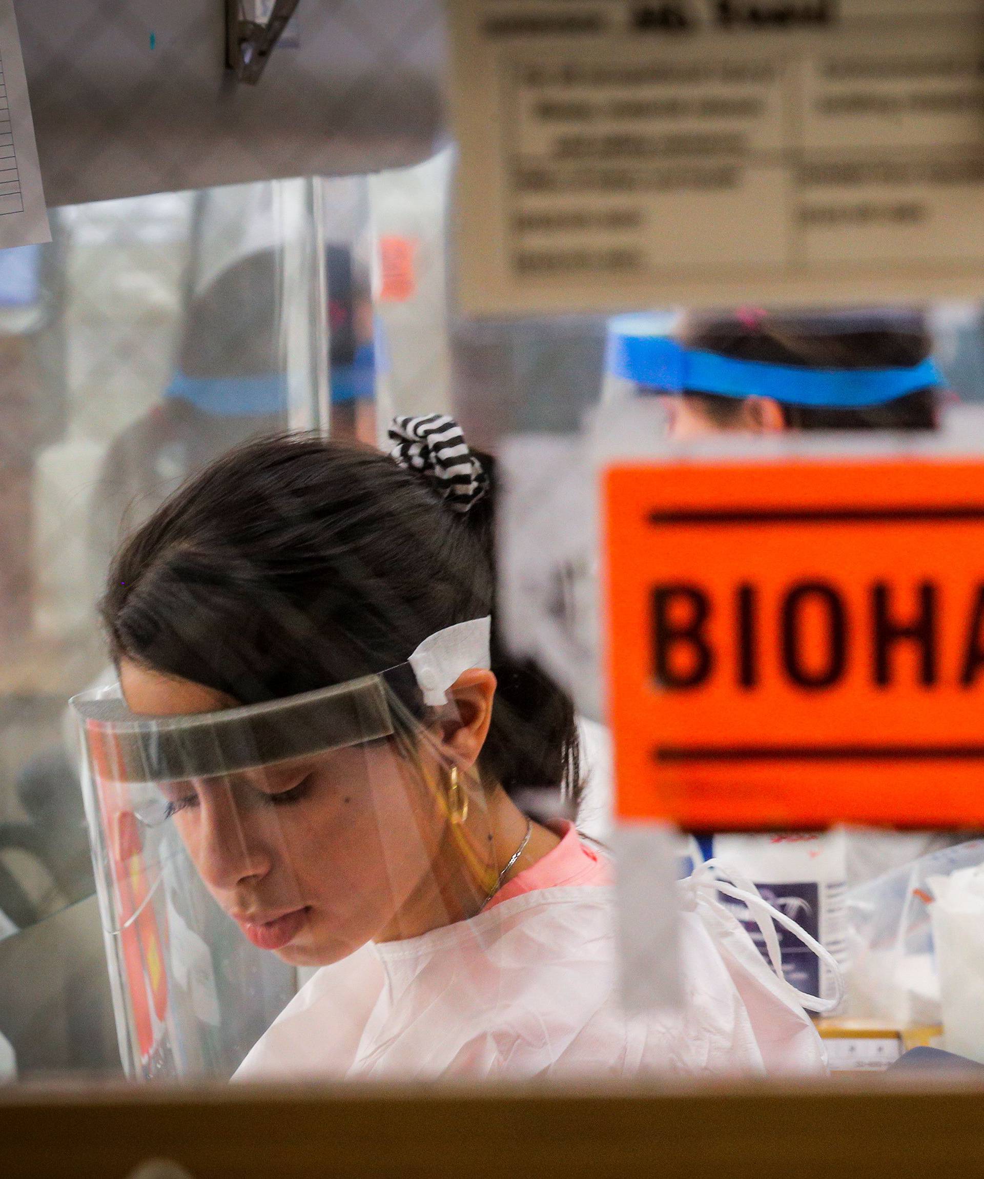 Scientists work in a lab testing COVID-19 samples at New York City's health department, during the outbreak of the coronavirus disease (COVID-19) in New York