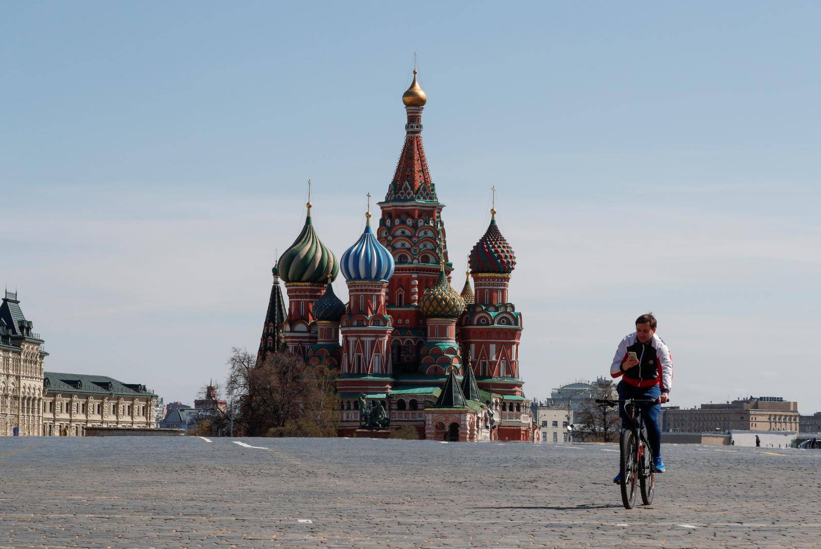 A man rides a bicycle along empty Red Square amid the coronavirus disease outbreak in Moscow