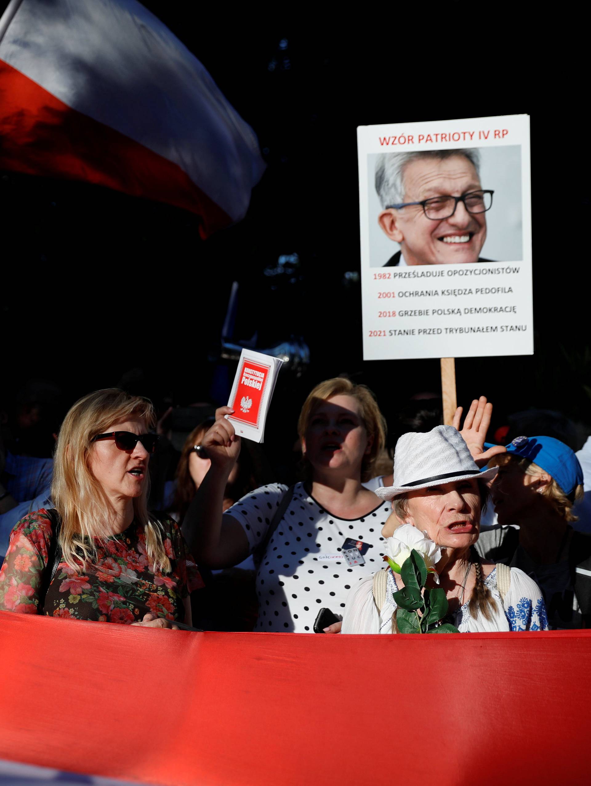 People gather during an anti-government protest in support of free courts in front of the the Senate building in Warsaw