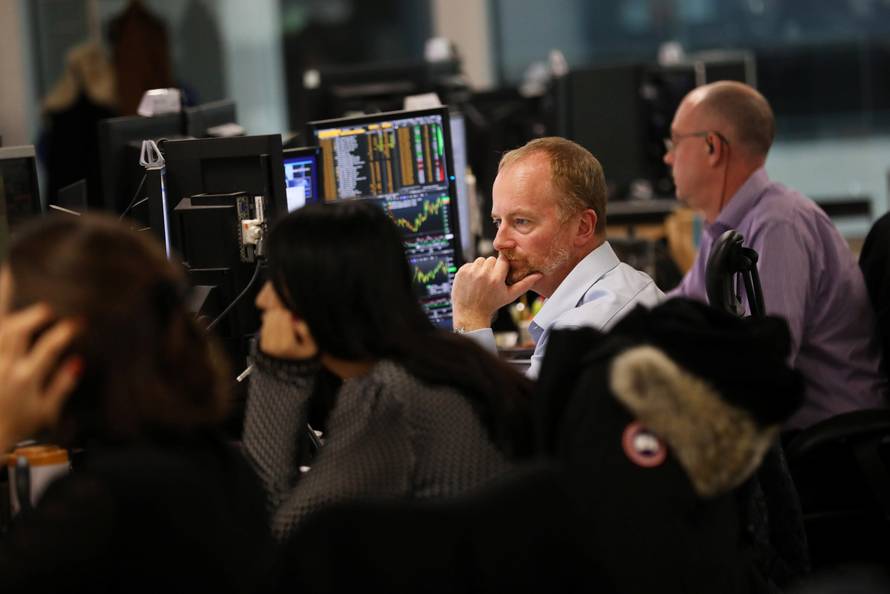 Investment managers, in the office of Aberdeen Standard Investments, watch Britain's Prime Minister, Theresa May, deliver a statement to the House of Commons, in London