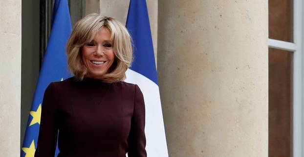 Brigitte Macron, wife of the French President, waits to welcome guests at the Elysee Palace in Paris