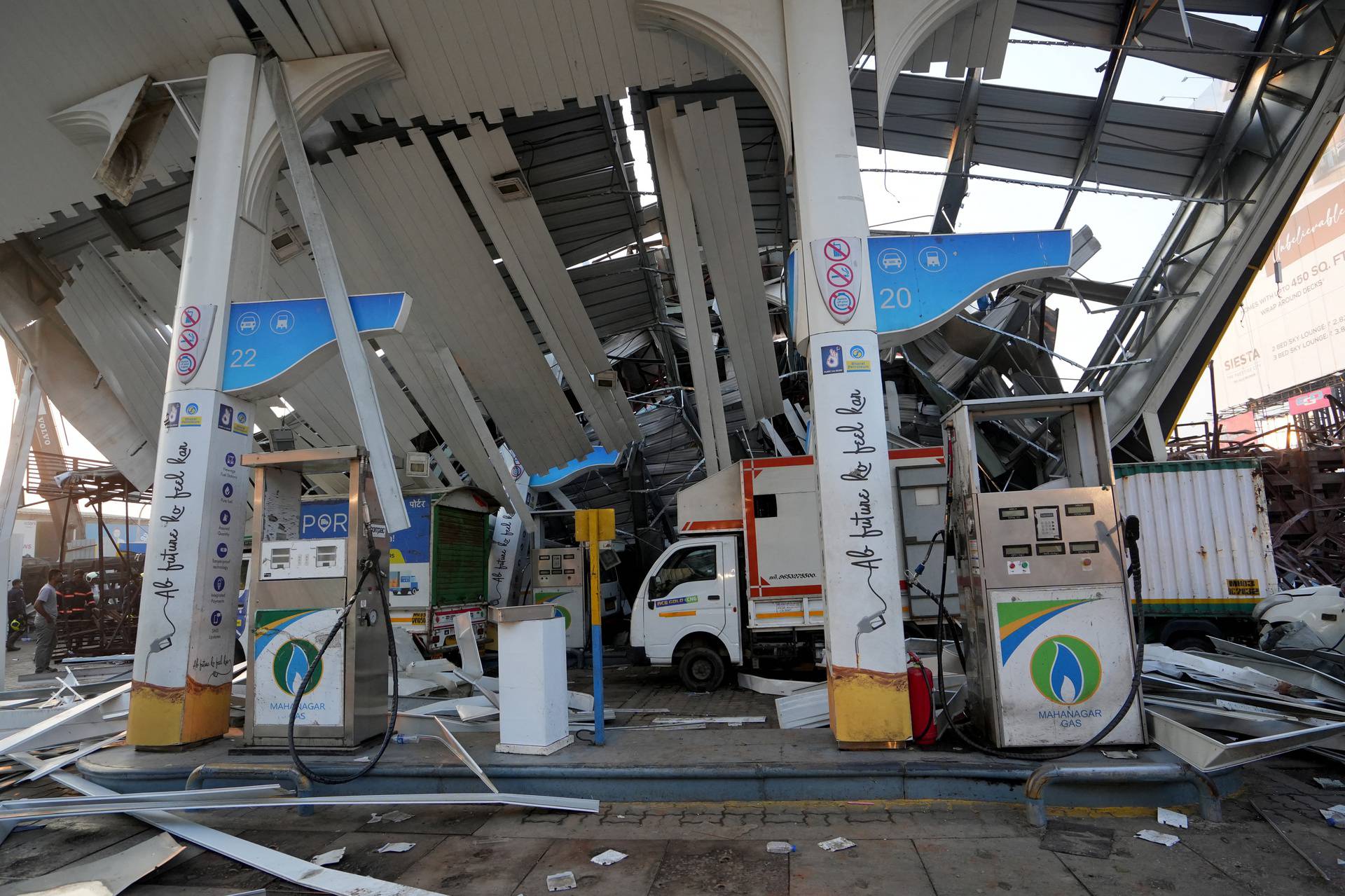 A view of damaged fuel station after a massive billboard fell during a rainstorm in Mumbai