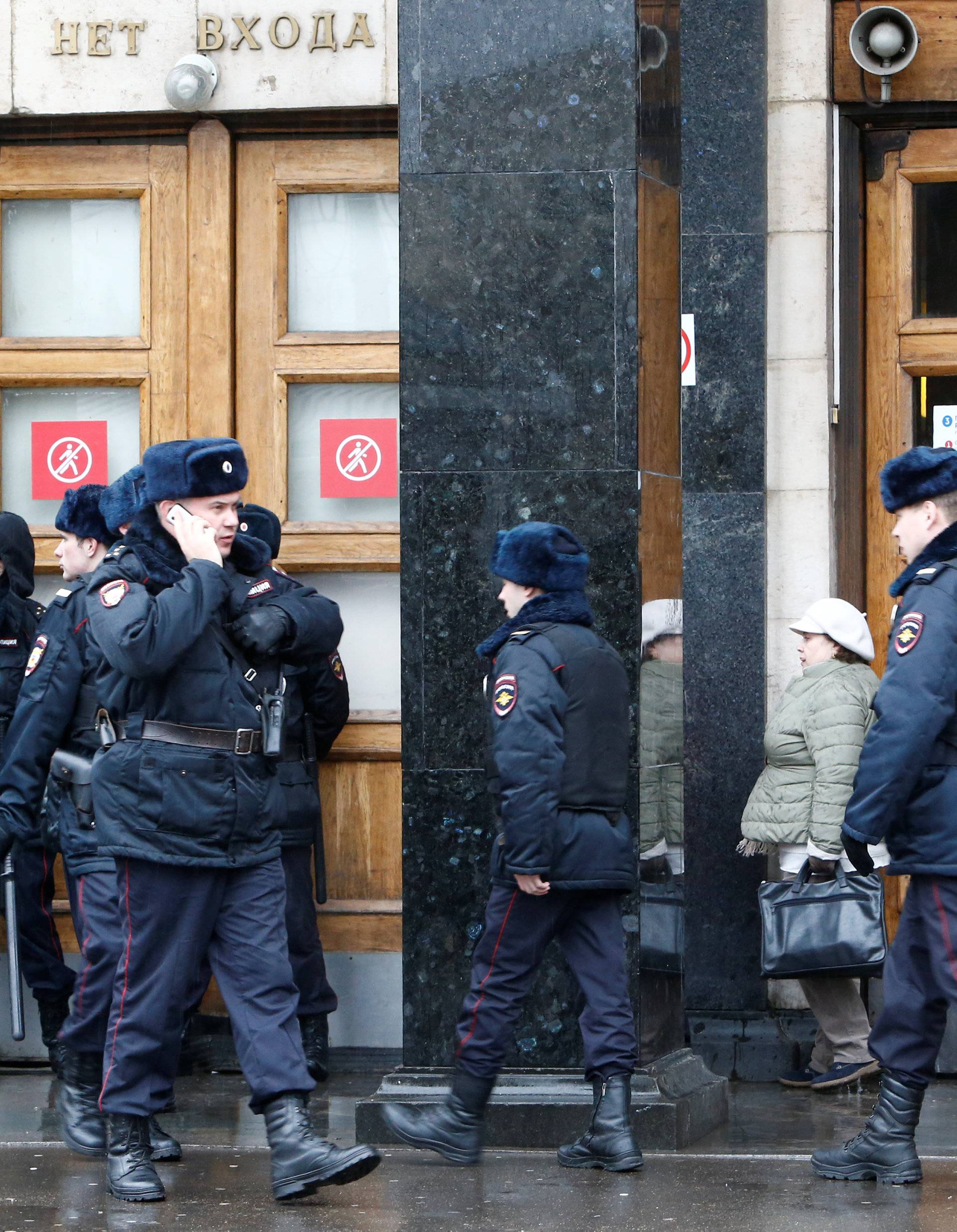 Police officers are seen outside Ploschad Revolyutsii metro station in Moscow