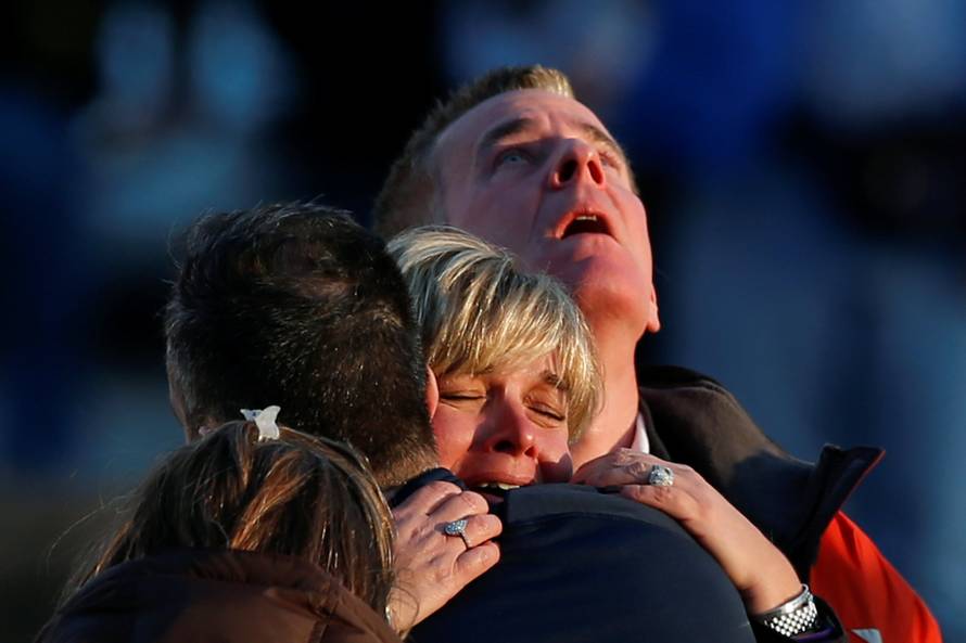 FILE PHOTO: Lynn and Christopher McDonnell, the parents of seven-year-old Grace McDonnell, grieve near Sandy Hook Elementary in Newtown,