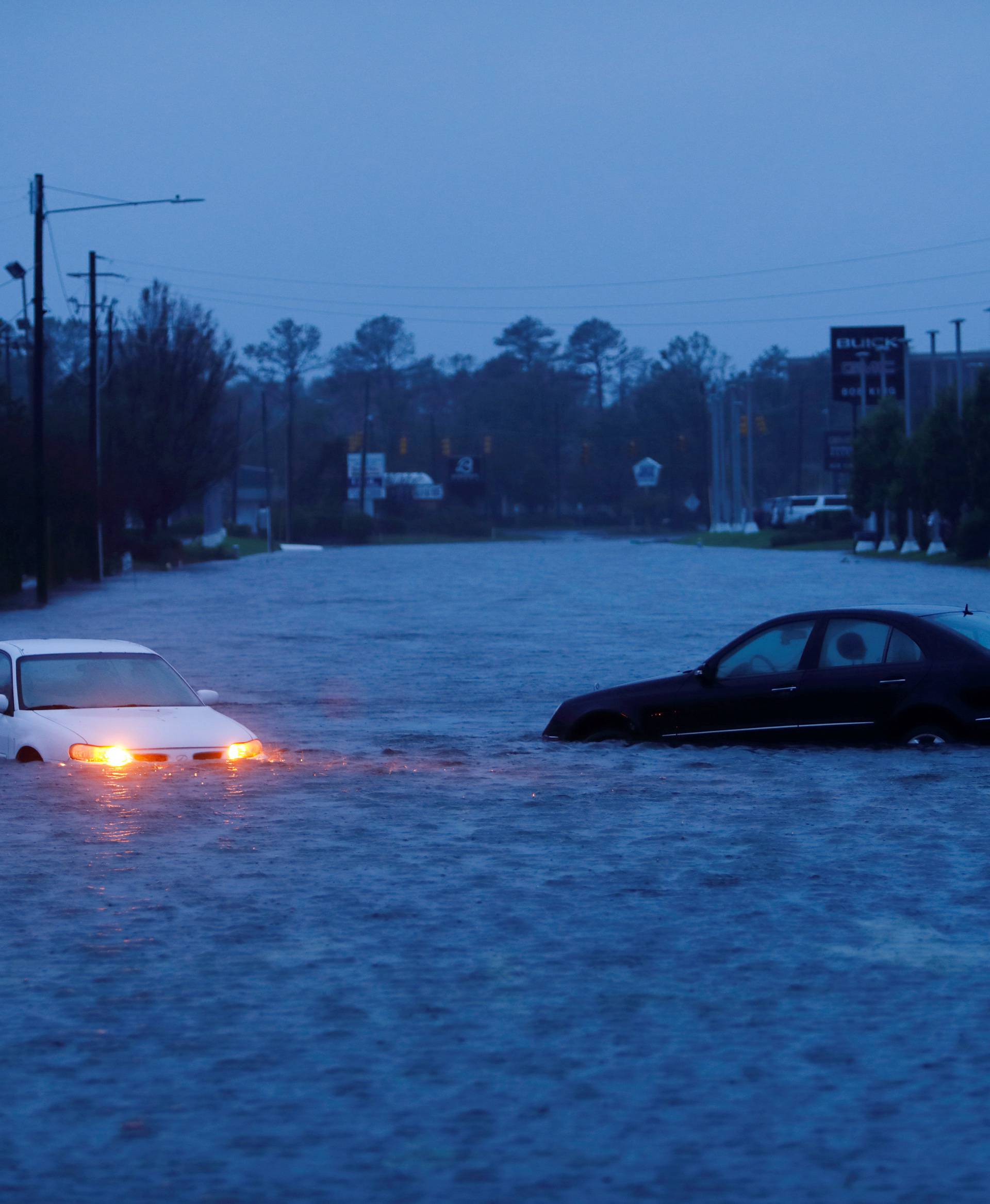 An abandoned car's hazard lights continue to flash as it sits submerged in a rising flood waters after Hurricane Florence struck in Wilmington, North Carolina