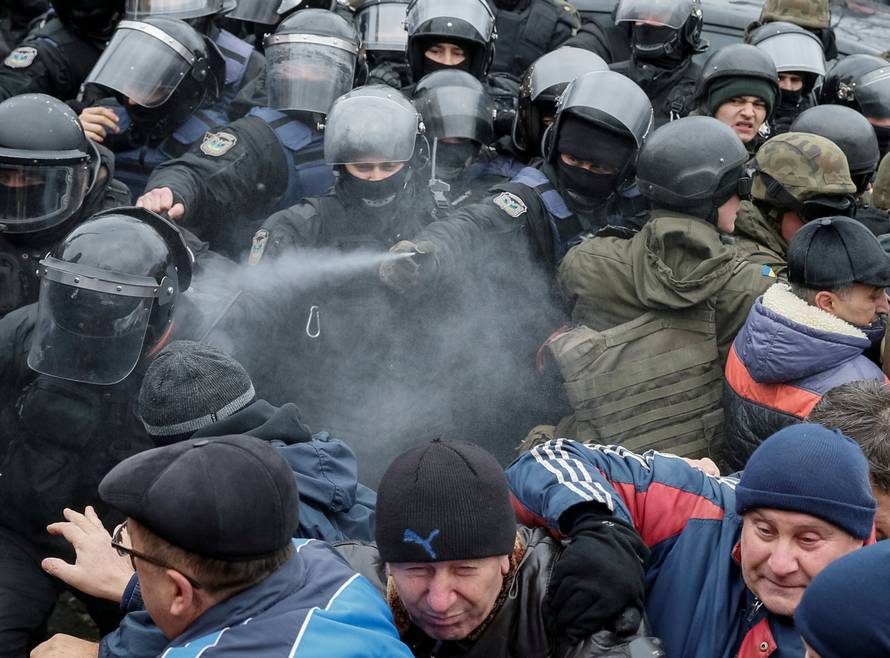 Police officers use tear gas against supporters of former Georgian President Saakashvili during clashes in Kiev