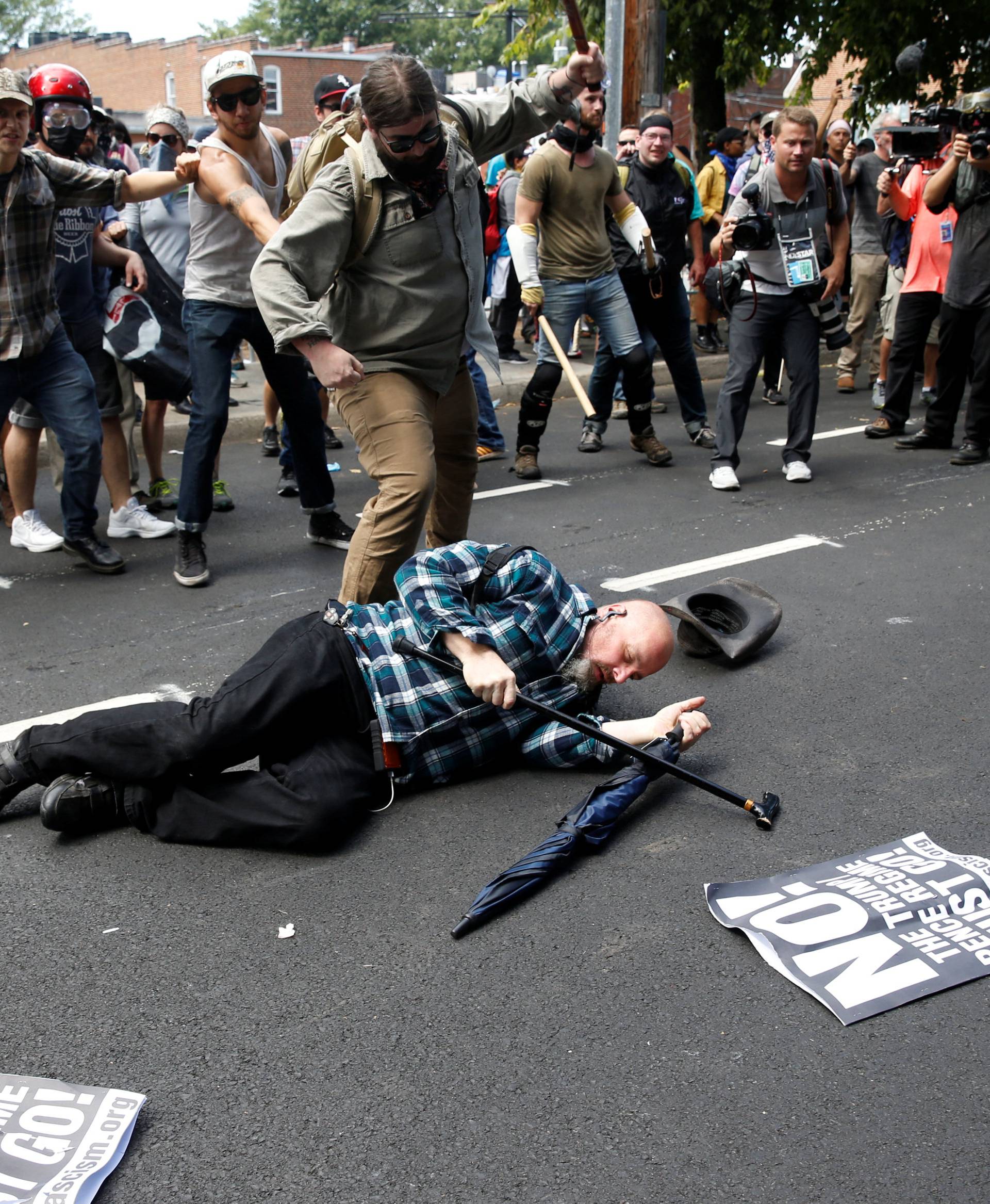 A man is down during a clash between members of white nationalist protesters and a group of counter-protesters in Charlottesville