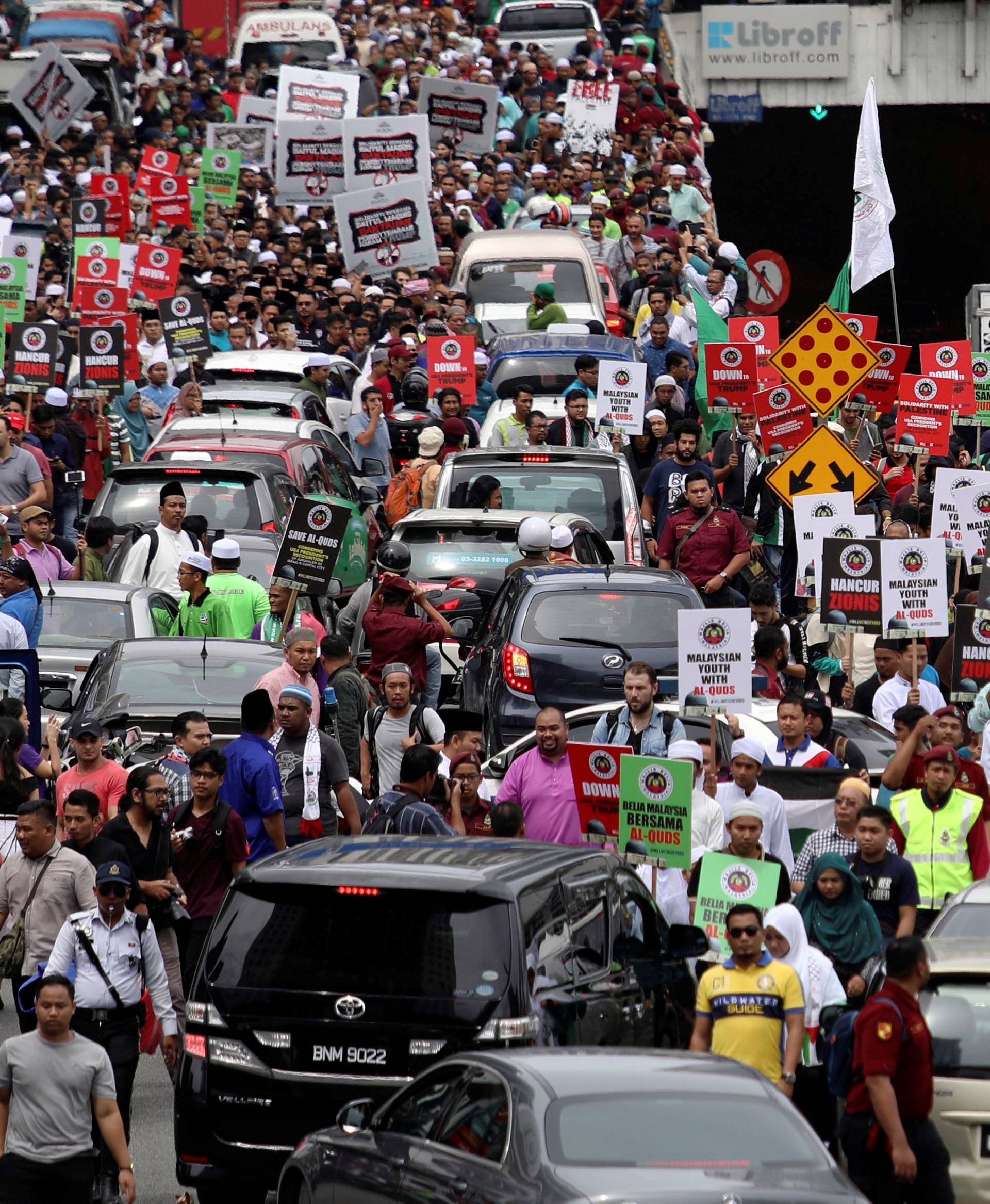 Pro-Palestine protesters march towards the U.S. embassy in Kuala Lumpur
