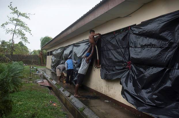 People use plastic trash bags to cover the windows of a school being used as a shelter as Hurricane Iota approaches Puerto Cabezas