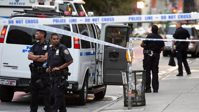 NYPD officers stand near the site of an explosion in New York