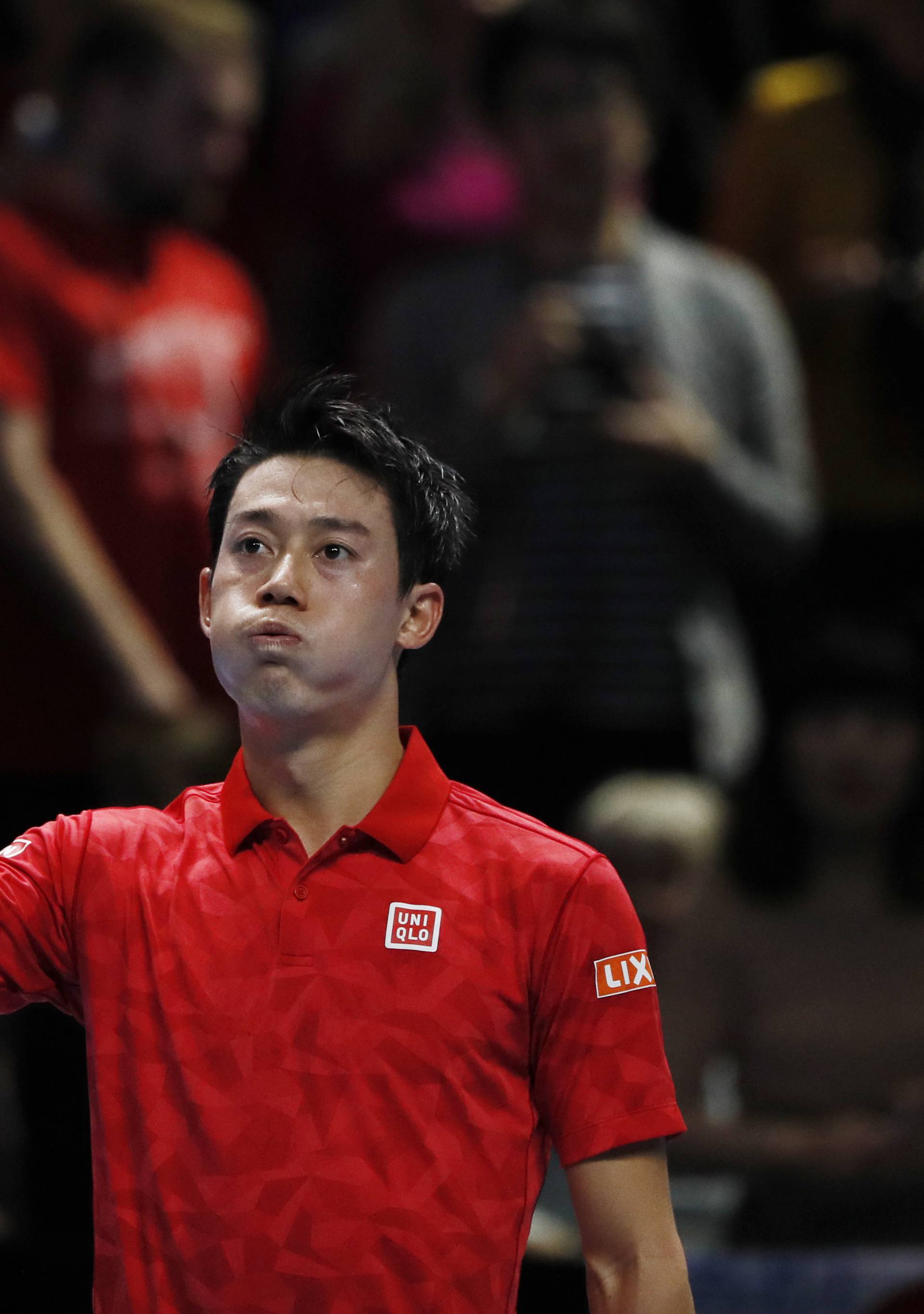 Japan's Kei Nishikori celebrates after winning his round robin match against Switzerland's Stanislas Wawrinka