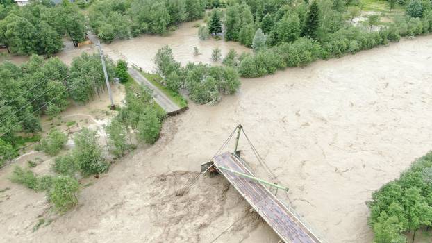 An aerial view shows destroyed bridge over the Chornyi Cheremosh river near the town of Verkhovyna in Ivano-Frankivsk region