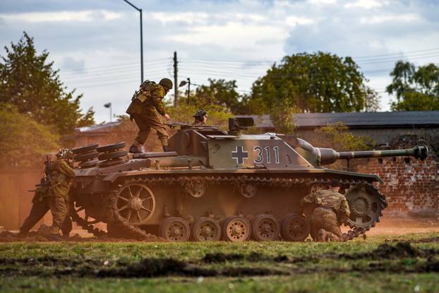 Reconstruction of historical soldiers attack on a tank during the Second World War.