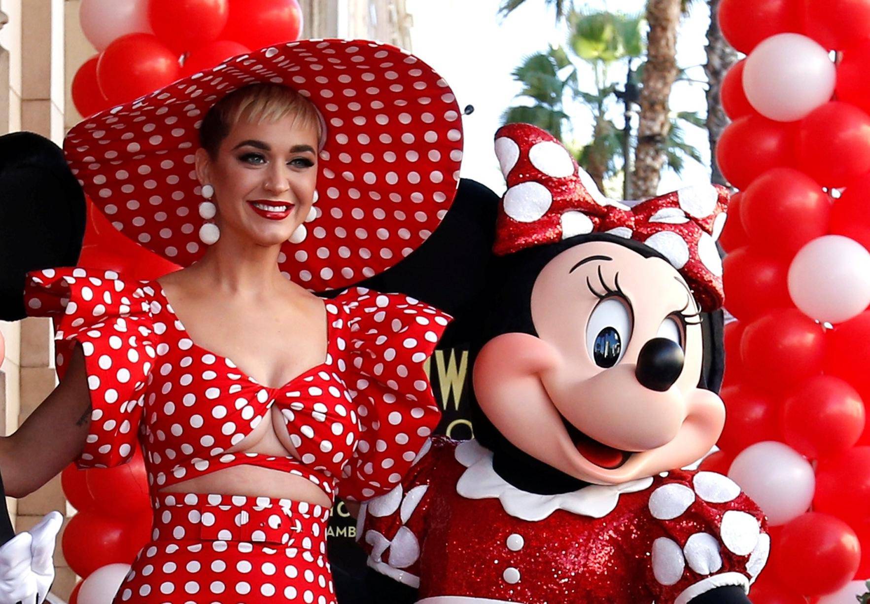 Singer Perry poses with the characters of Mickey Mouse and Minnie Mouse at the unveiling of the star for Minnie Mouse on the Hollywood Walk of Fame in Los Angeles