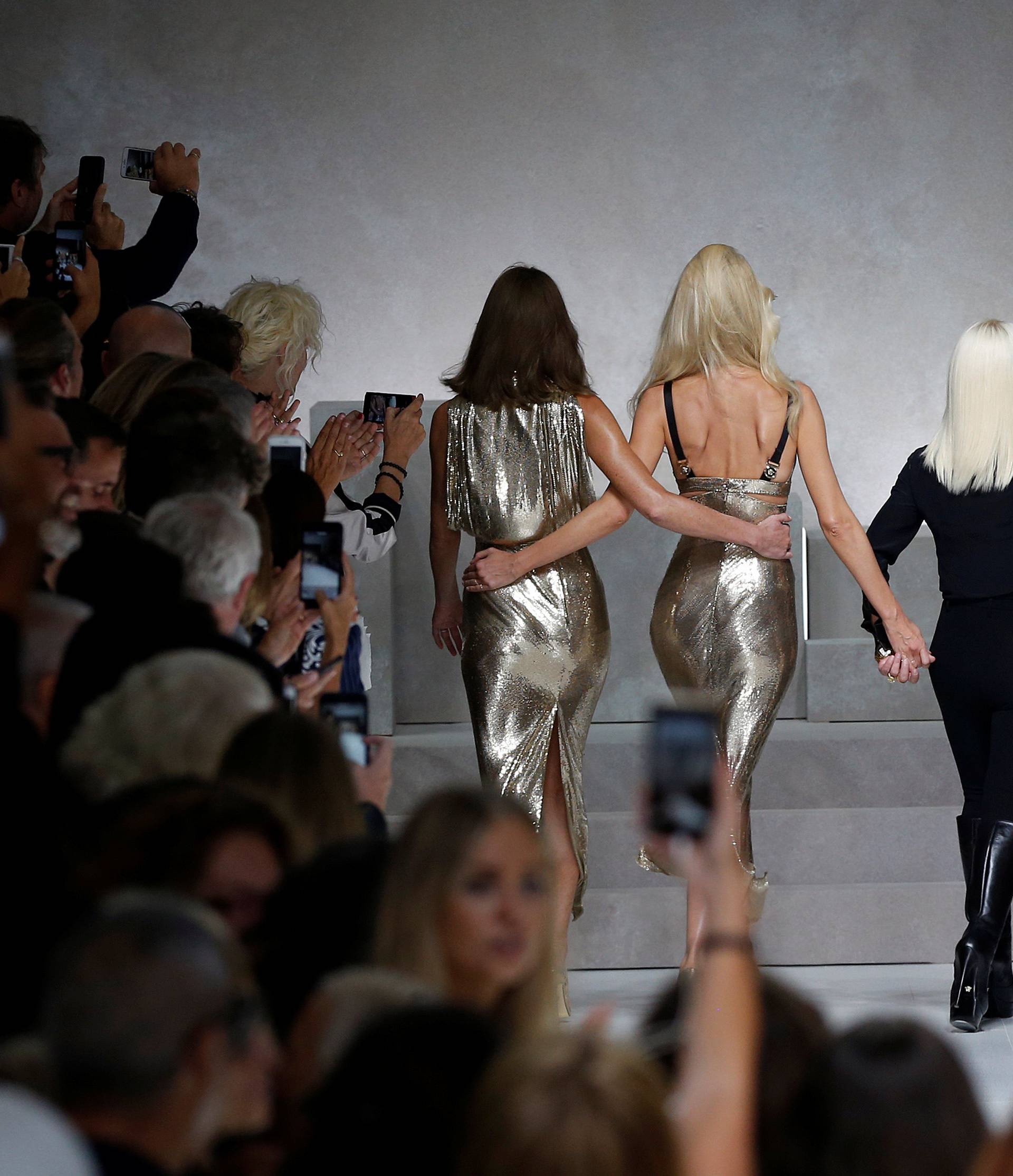 Italian designer Donatella Versace acknowledges the applause with former top models Carla Bruni, Claudia Schiffer, Naomi Campbell, Cindy Crawford and Helena Christensen at the end of Versace Spring/Summer 2018 show at the Milan Fashion Week in Milan