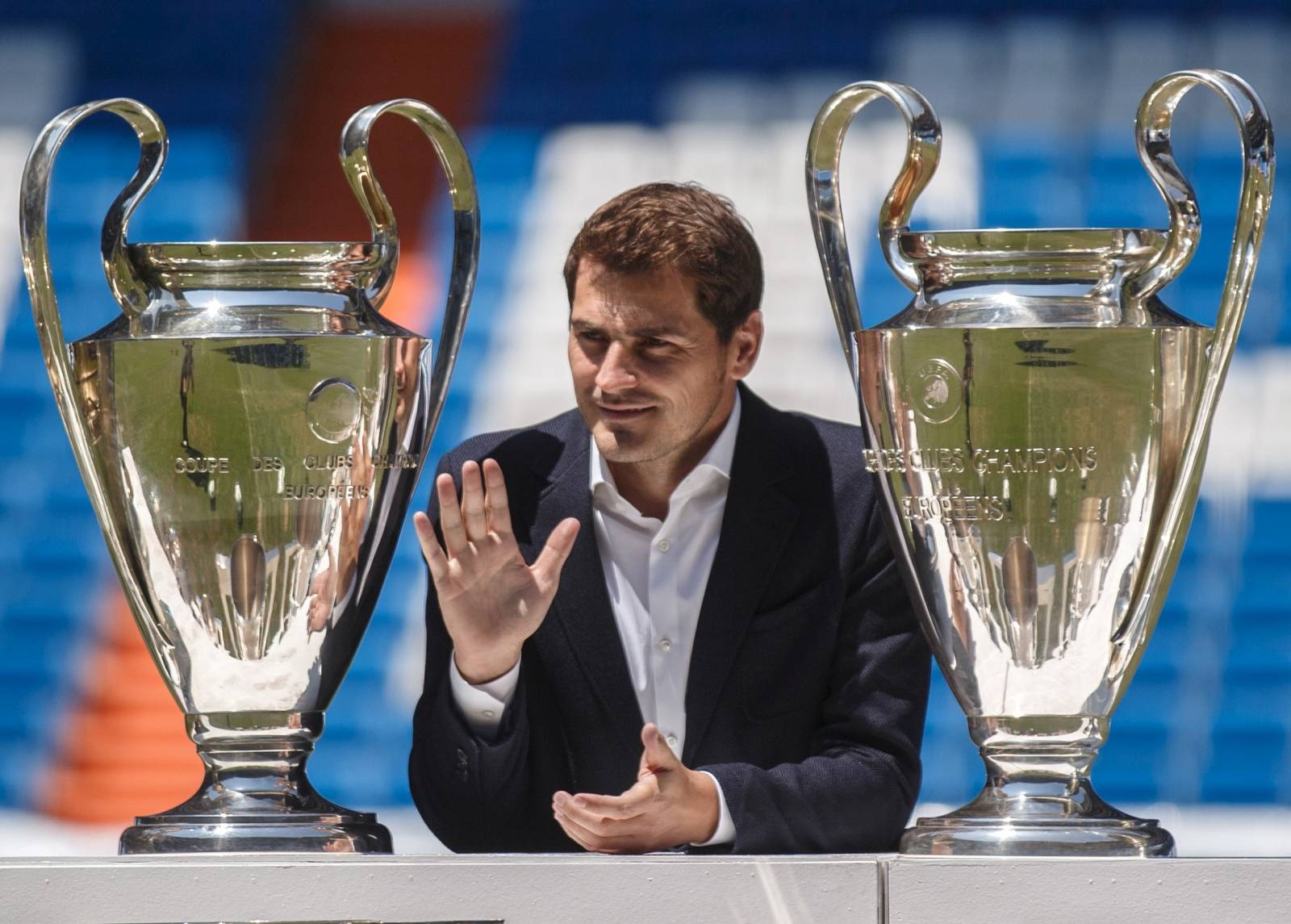 FILE PHOTO: Departing Real Madrid captain and goalkeeper Iker Casillas waves as he poses surrounded by trophies at an official send-off at the Bernabeu stadium in Madrid, Spain