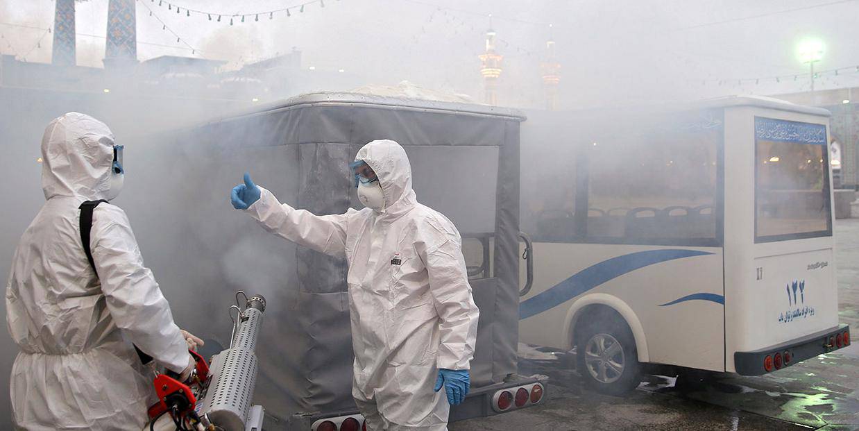 Members of the medical team spray disinfectant to sanitize outdoor place of Imam Reza's holy shrine, following the coronavirus outbreak, in Mashhad