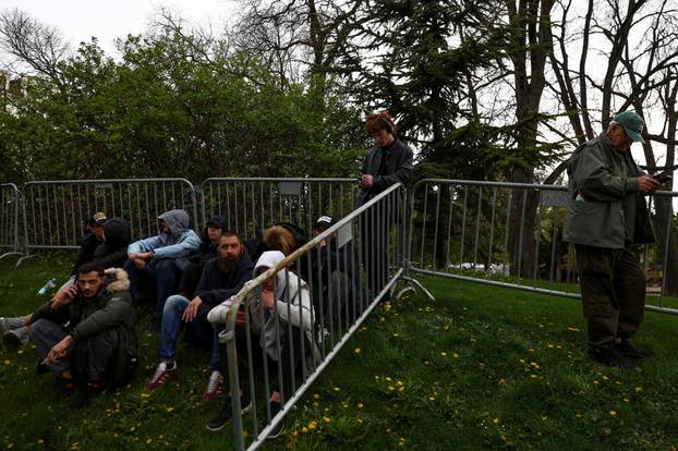 People attend a rally in support of policies of the President Aleksandar Vucic
