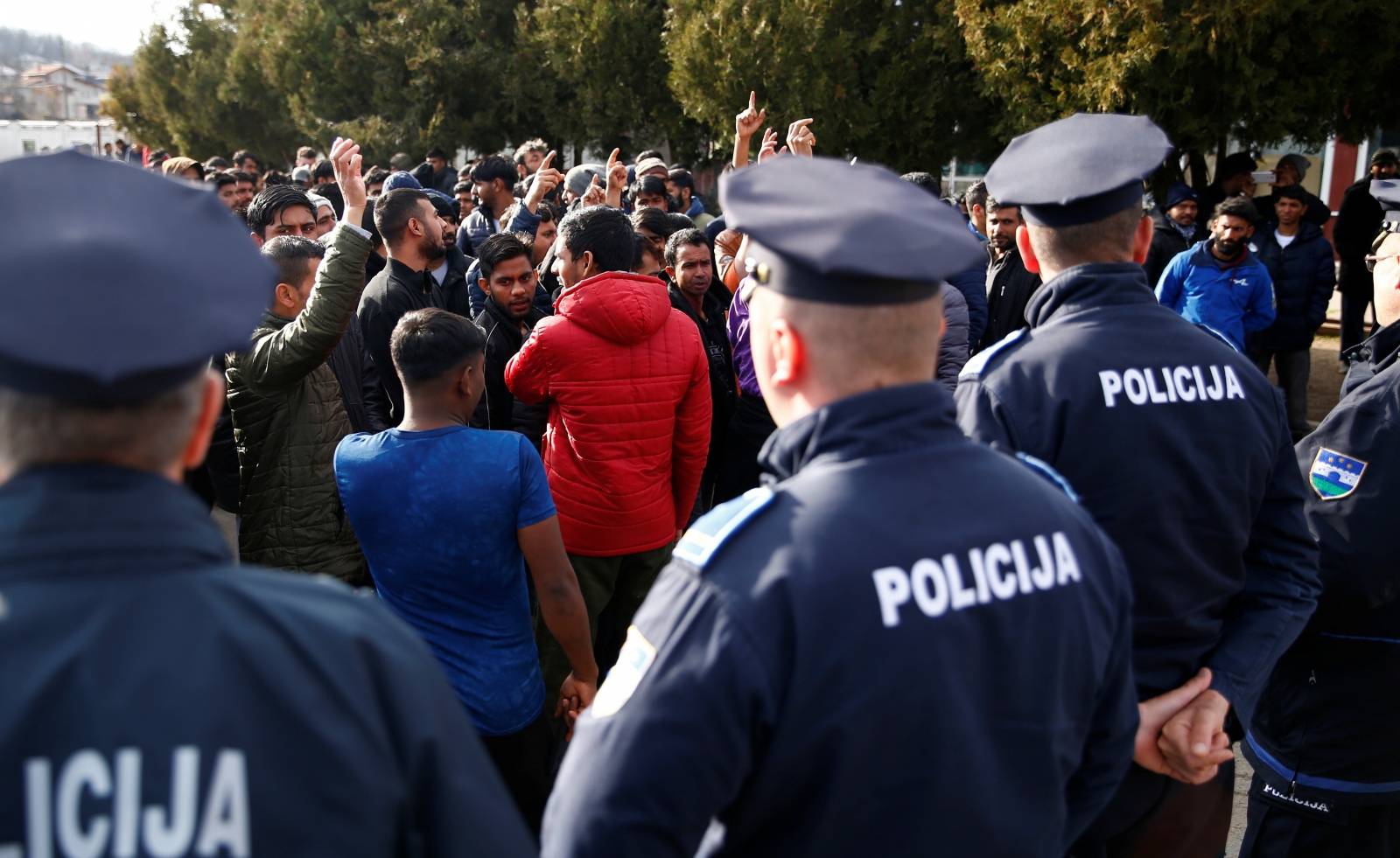 Migrants are stoped by police while trying to block road in front of the refugee camp Miral in Velika Kladusa