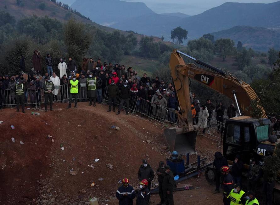 People gather as rescuers work to reach a five-year old boy trapped in a well in the northern hill town of Chefchaouen