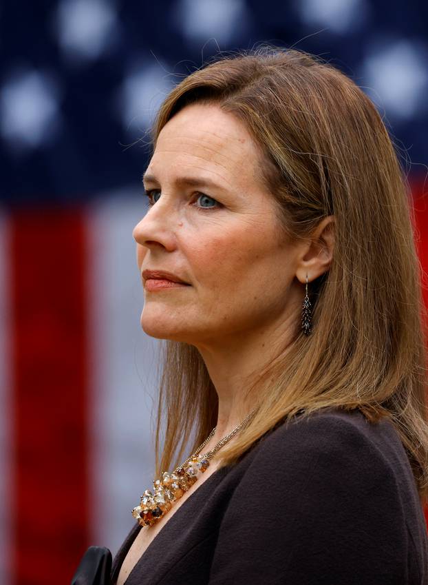 U.S. Court of Appeals for the Seventh Circuit Judge Amy Coney Barrett stands as U.S President Donald Trump holds an event to announce her nomination for the Supreme Court at the White House in Washington