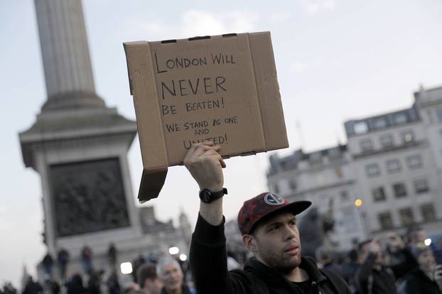 People attend a vigil in Trafalgar Square the day after an attack, in London