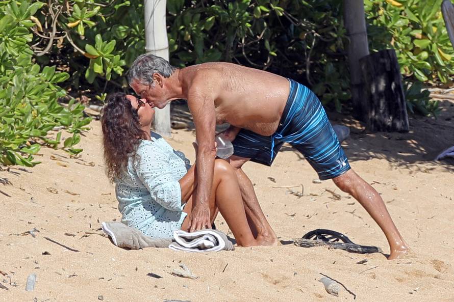 EXCLUSIVE: A shirtless Pierce Brosnan hits the beach and gives his wife Keely Shaye Smith a tender kiss after snorkeling while in Hawaii