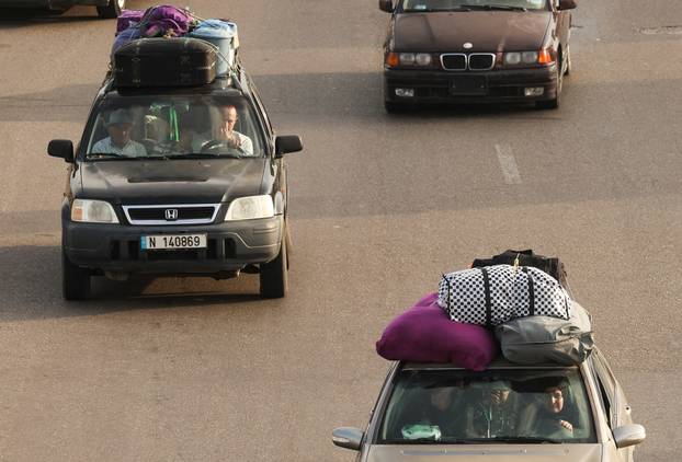 Displaced people make their way as they return to their homes after a 10-day ceasefire between Lebanon and Israel went into effect, in Sidon
