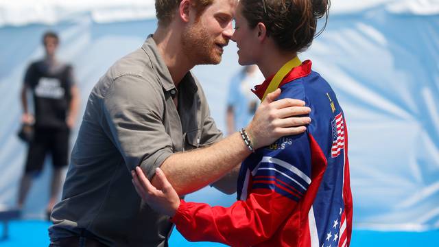 Britain's Prince Harry greets Elizabeth Marks of the U.S. after presenting her with a gold medal during a medal ceremony at the Invictus Games in Orlando