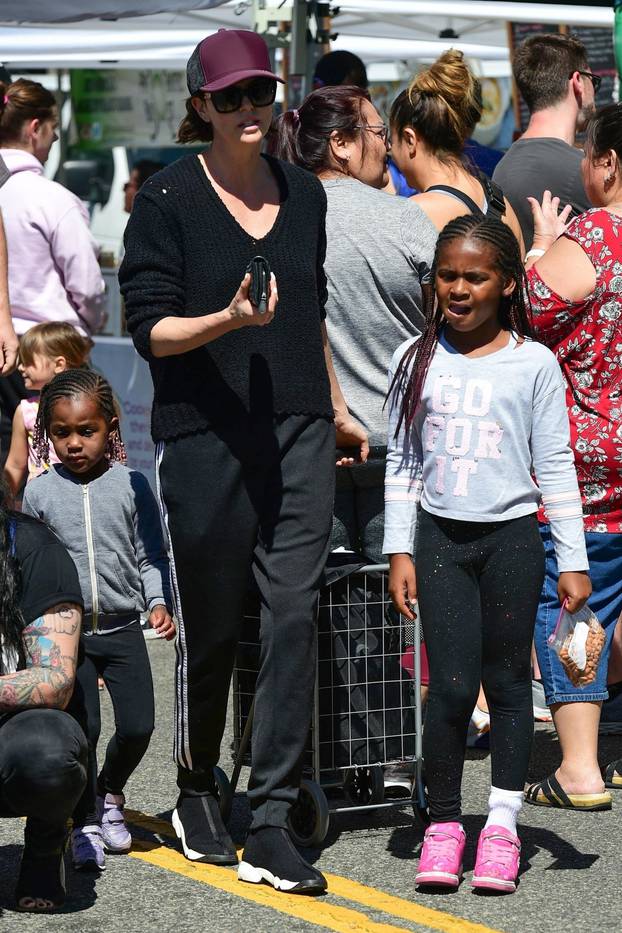 Charlize Theron shops with her kids at the Farmer