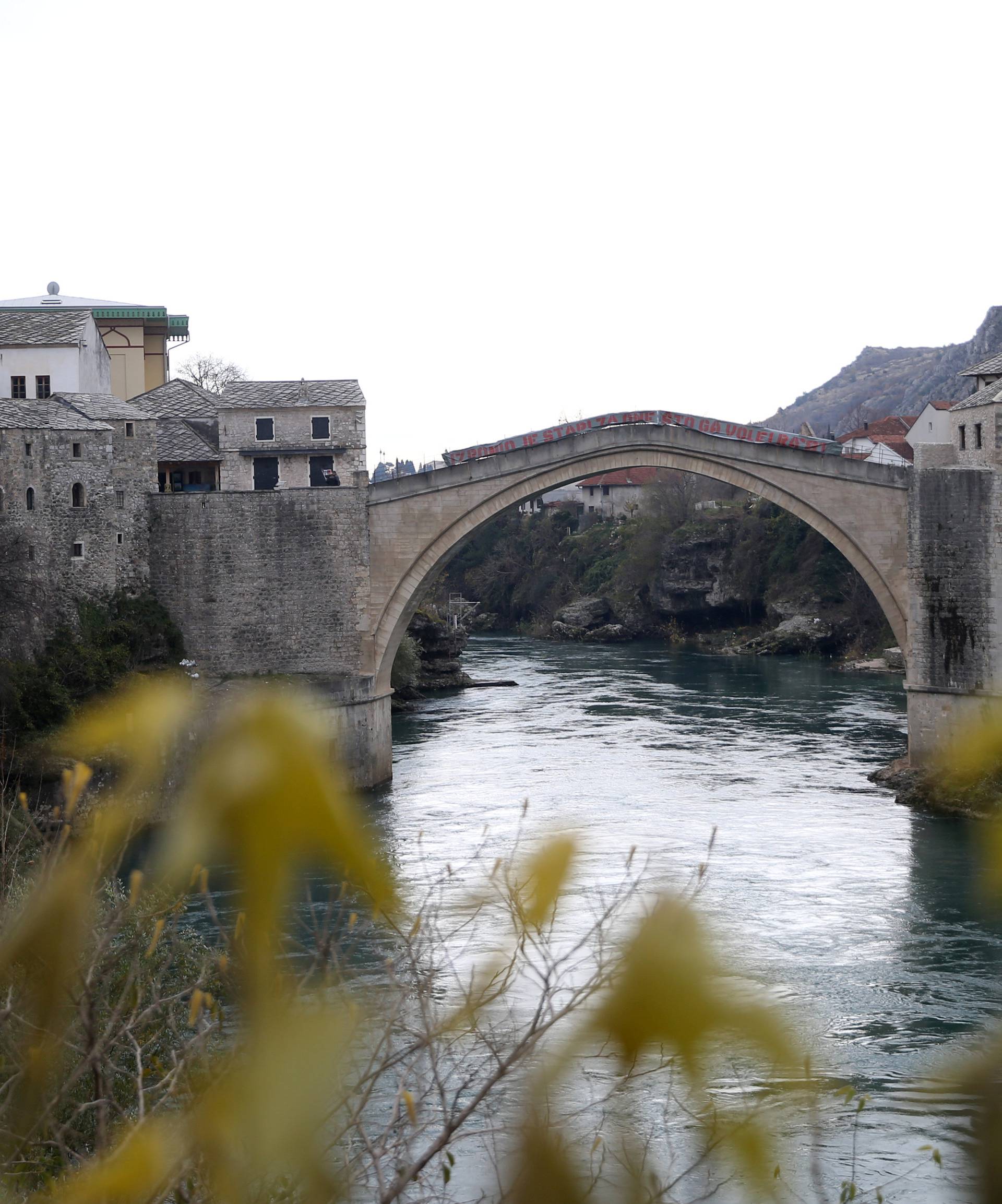 Old Bridge is seen with poster which reads: "The old bridge surfaced for the ones who love it" in Mostar