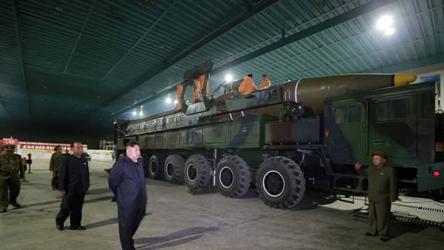 North Korean leader Kim Jong Un inspects the intercontinental ballistic missile Hwasong-14 in this undated photo released by KCNA