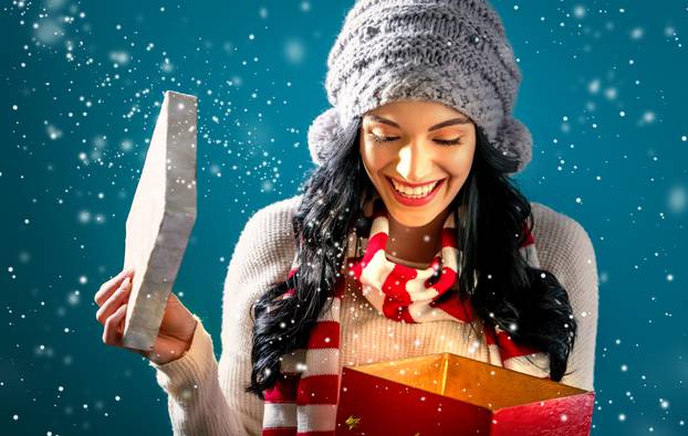 Happy young woman with Christmas present box