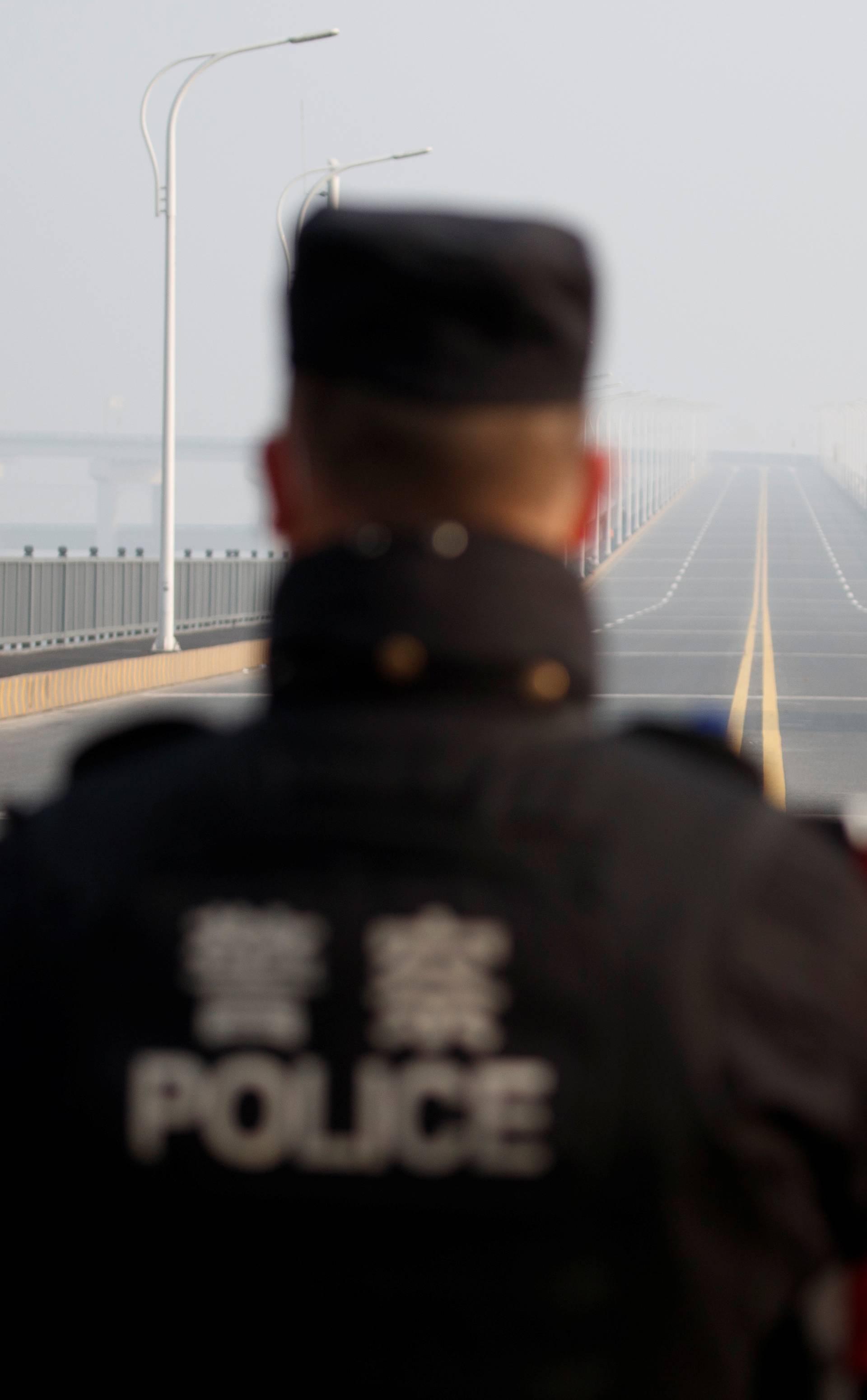 A man arriving from Hubei province approaches a checkpoint at the Jiujiang Yangtze River Bridge in Jiujiang