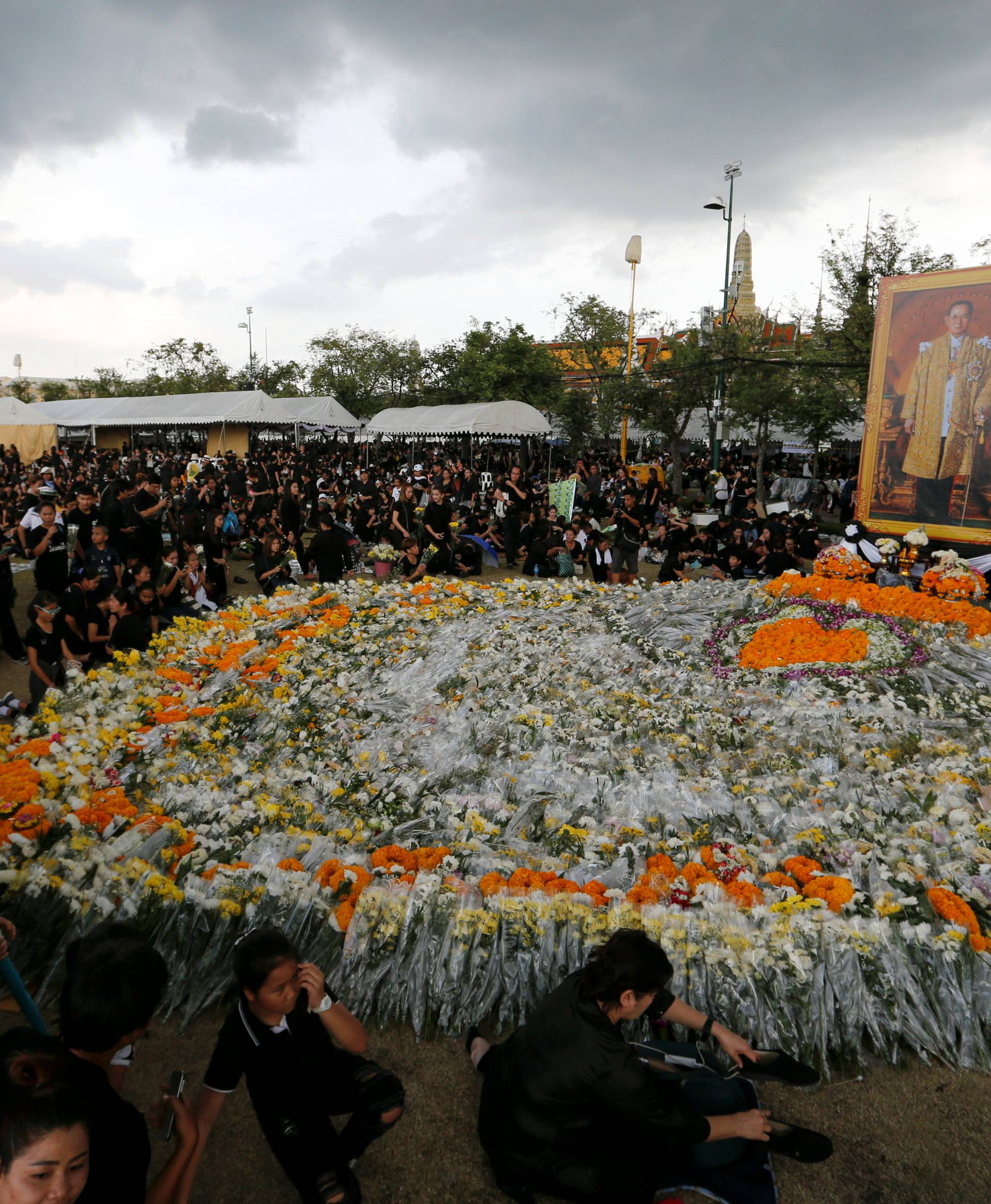Mourners place flowers outside of the Grand Palace in honour of Thailand's late King Bhumibol Adulyadej in Bangkok