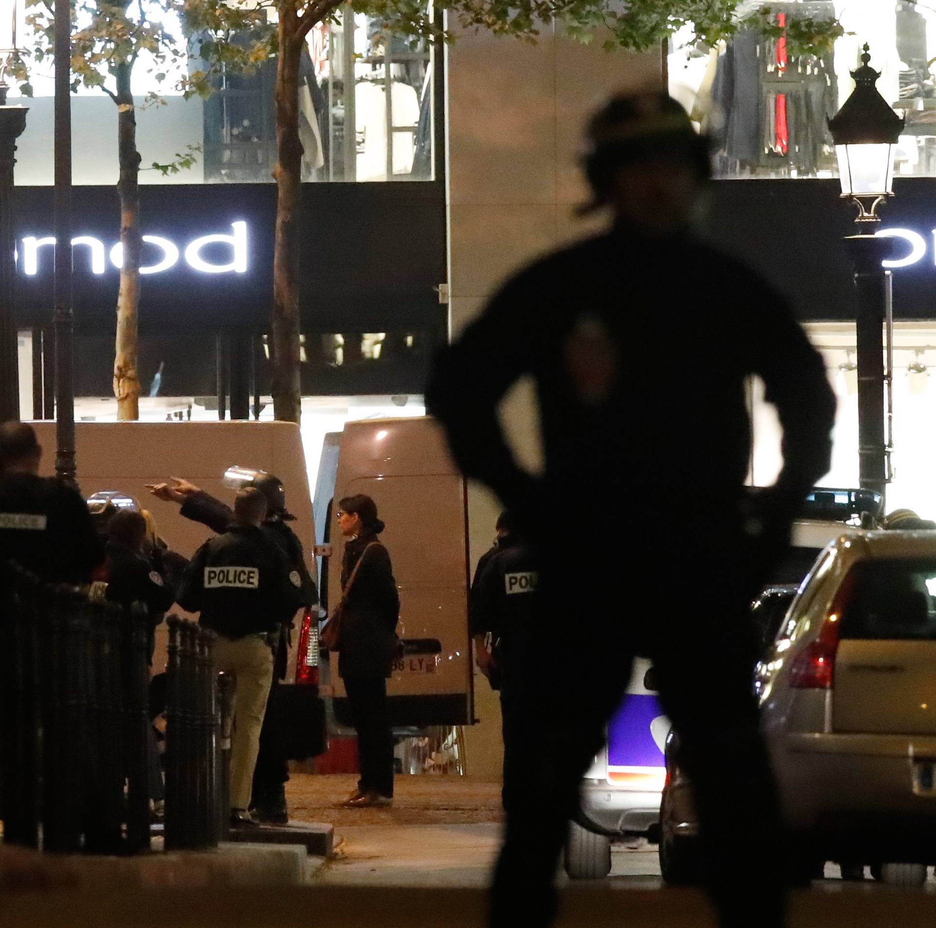 Police secure a side street as other conduct an investigation on the Champs Elysees Avenue after one policeman was killed and another wounded in a shooting incident in Paris