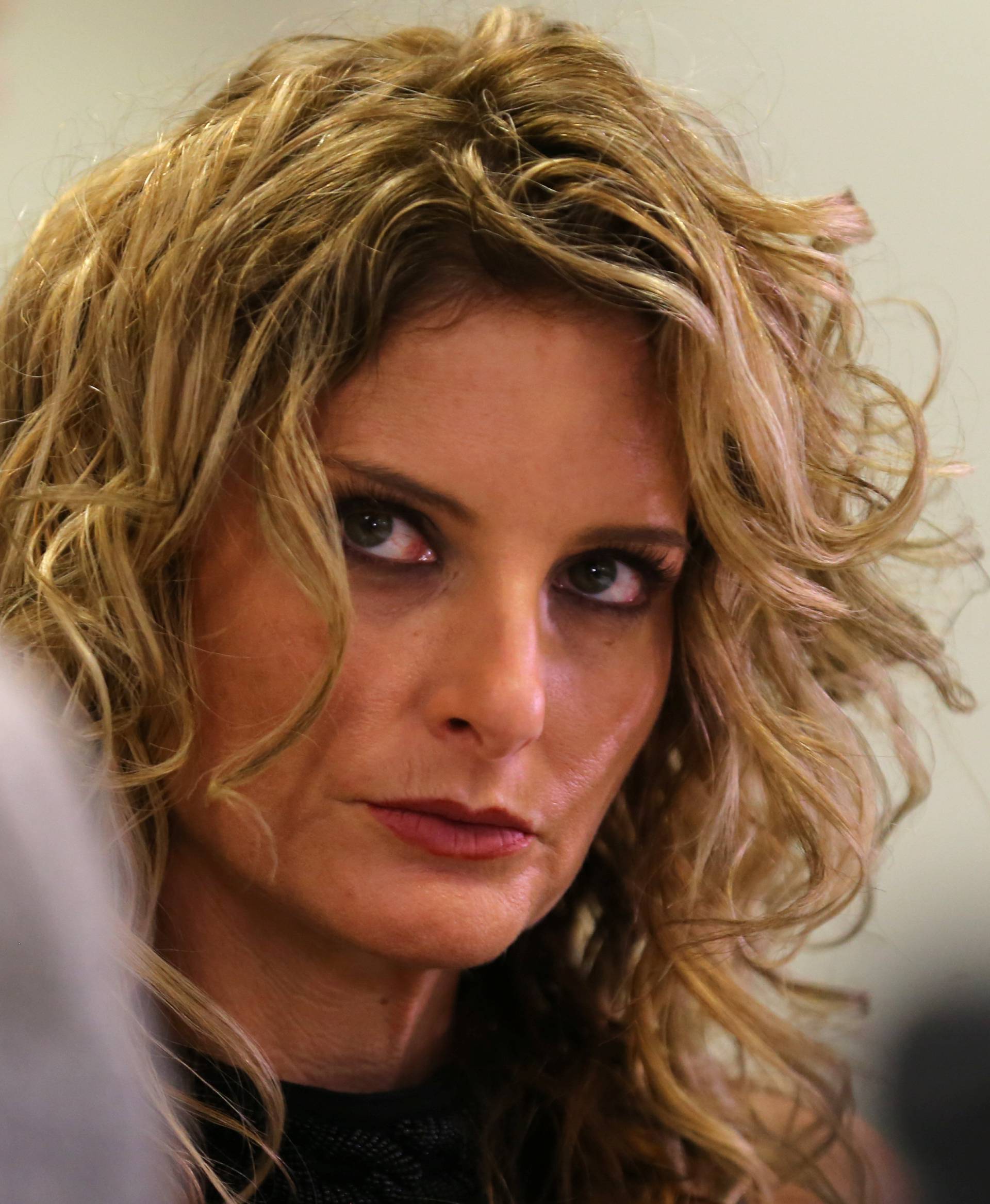 Summer Zervos listens as her attorney Gloria Allred speaks during a news conference announcing the filing of a lawsuit against President-elect Donald Trump in Los Angeles