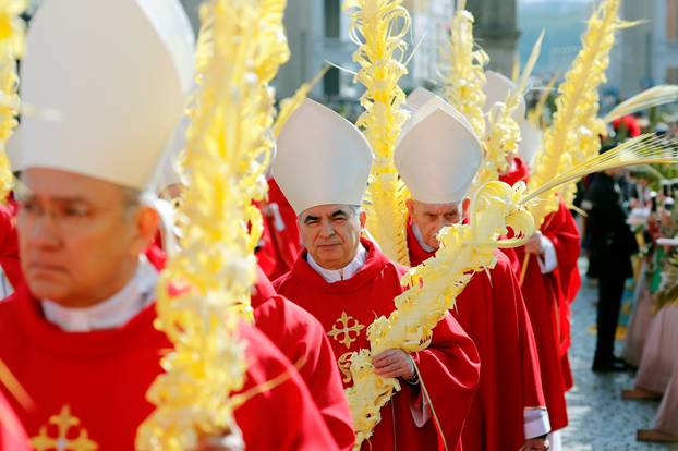 Cardinal Angelo Becciu arrives for the Palm Sunday Mass led by Pope Francis in Saint Peter