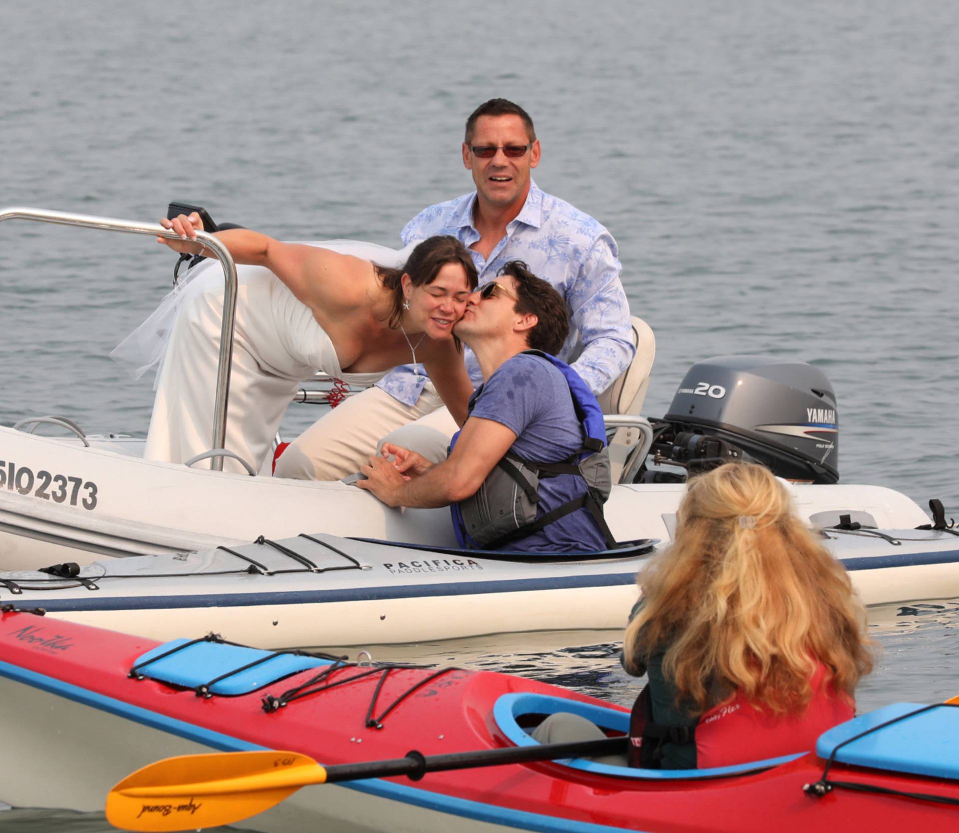 Newlyweds Michelle and Heiner Gruetzner approach Canada's Prime Minister Justin Trudeau while he was kayaking off Sidney