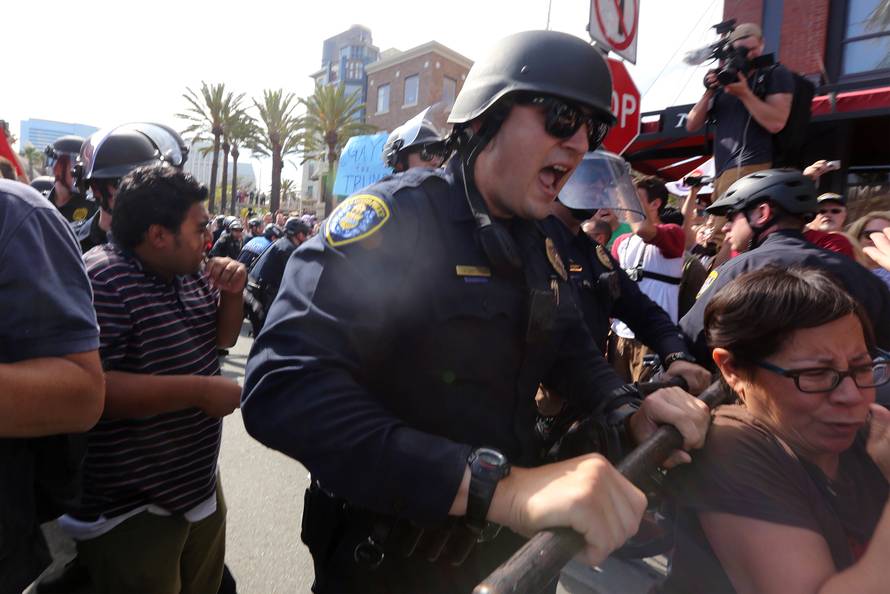 Police shove demonstrators outside a campaign event for Republican U.S. presidential candidate Donald Trump in San Diego