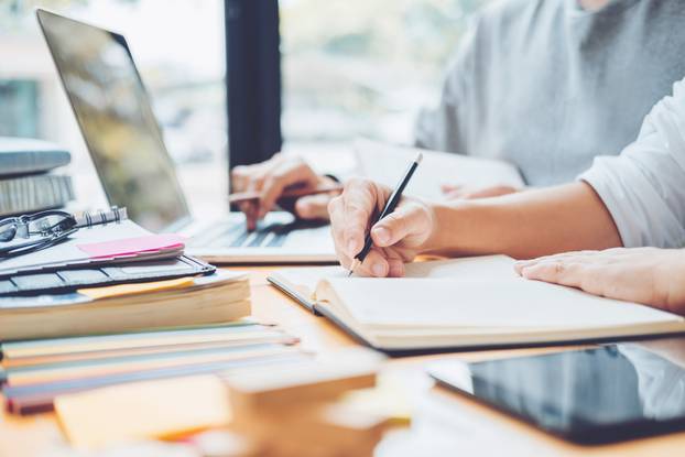 High school or college students studying and reading together in