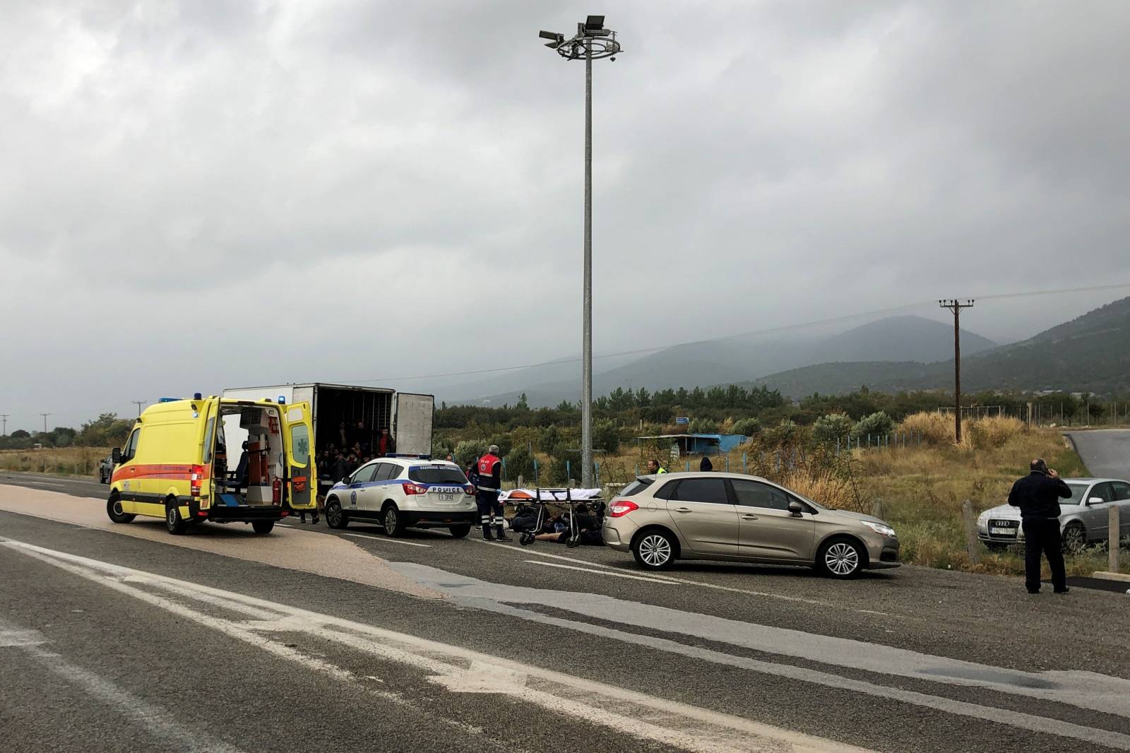 Migrants are seen inside a refrigerated truck found by police, after a check at a motorway near Xanthi