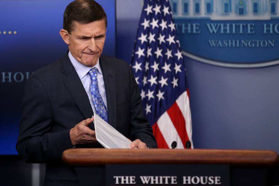 National security adviser General Michael Flynn (L) arrives to deliver a statement next to Press Secretary Sean Spicer during the daily briefing at the White House in Washington U.S.