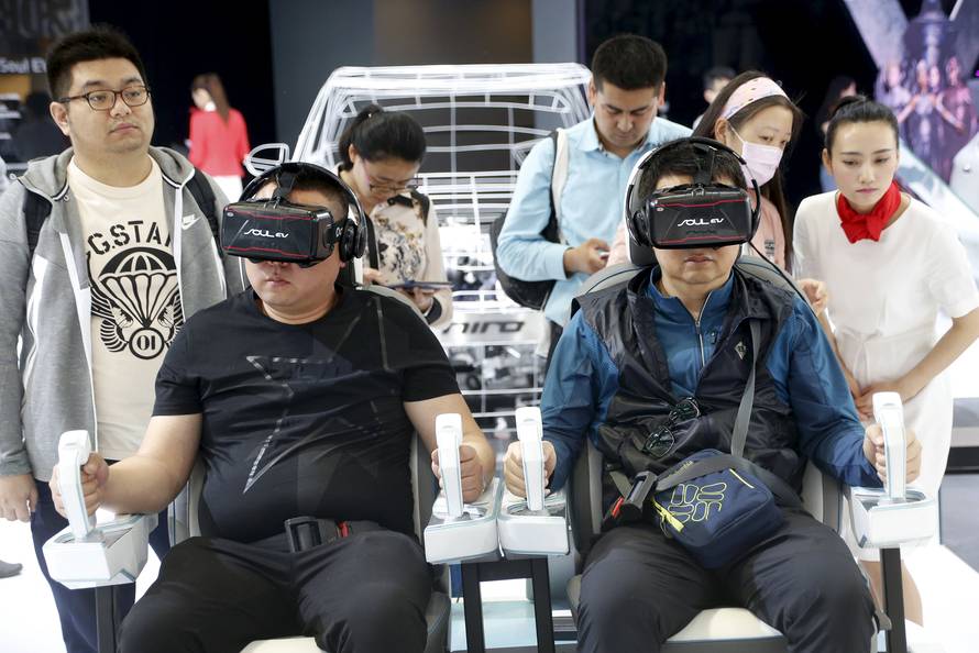 Visitor use VR experience technology at the booth of Kia Motors during the Auto China 2016 auto show in Beijing