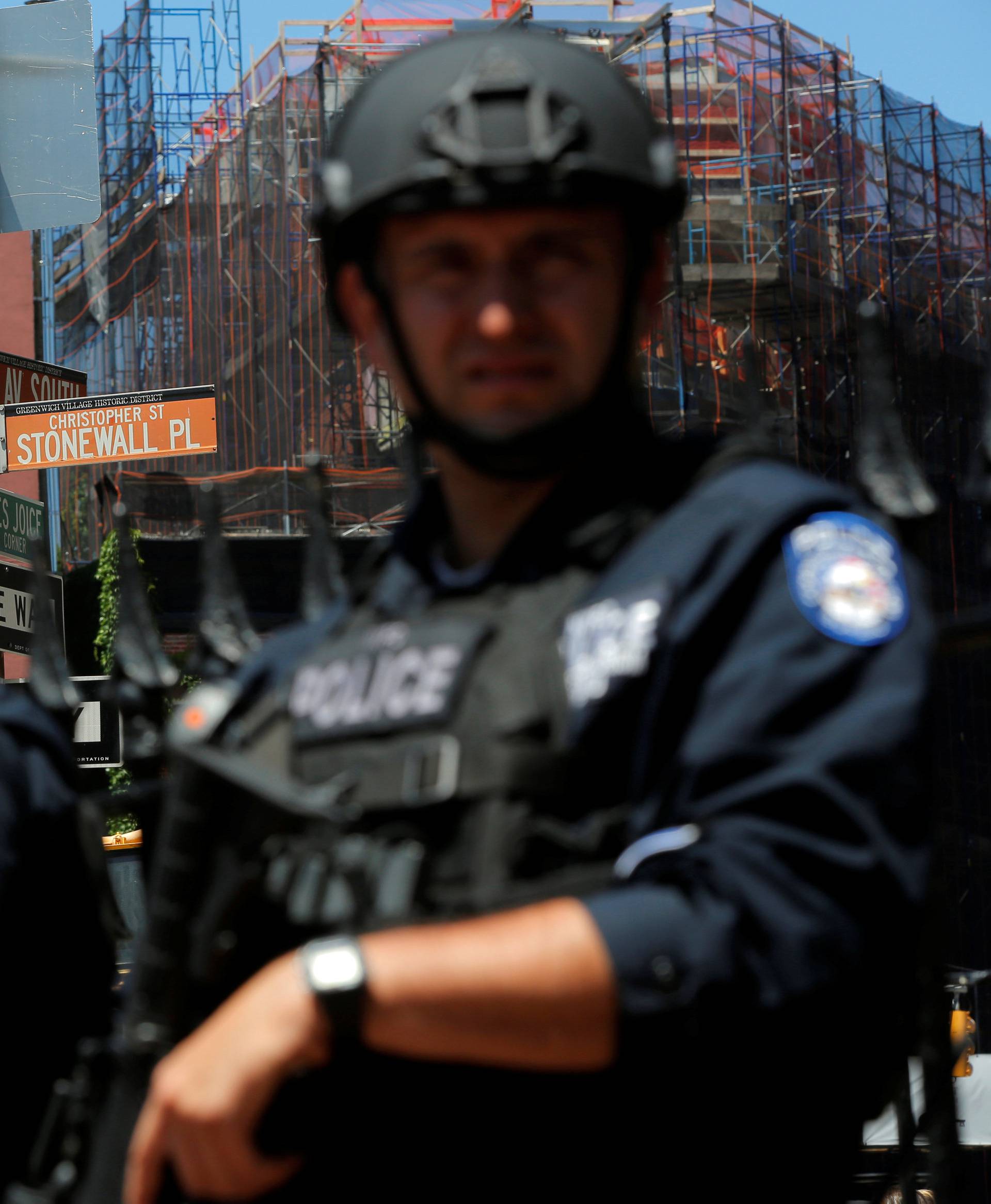 Members of the New York Police Department's Critical Response Command Unit stand guard on Christopher Street, in Manhattan